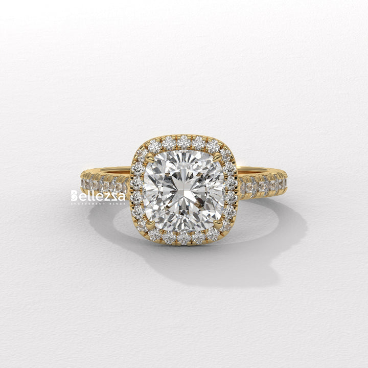 Gold ring with a large diamond and smaller diamonds on a white background, branded 'Bellezza'.